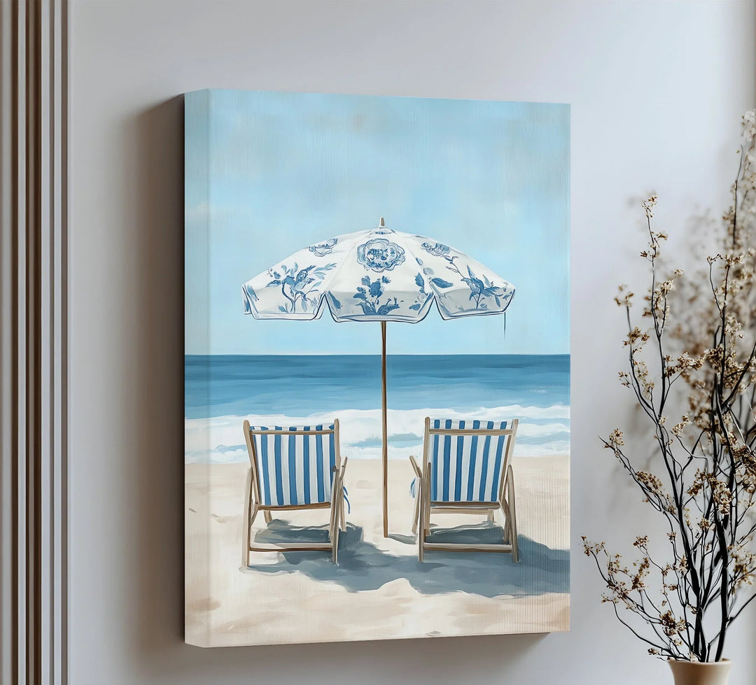 Relax by the waves with this serene canvas wall art of striped chairs and ocean breeze.