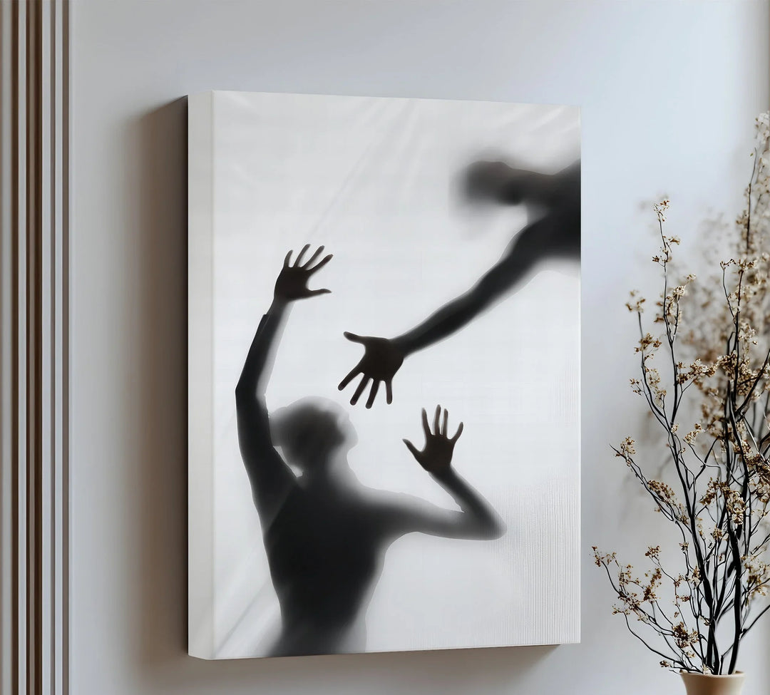 Silhouettes reach through shadows in this hauntingly beautiful canvas wall art of human connection.