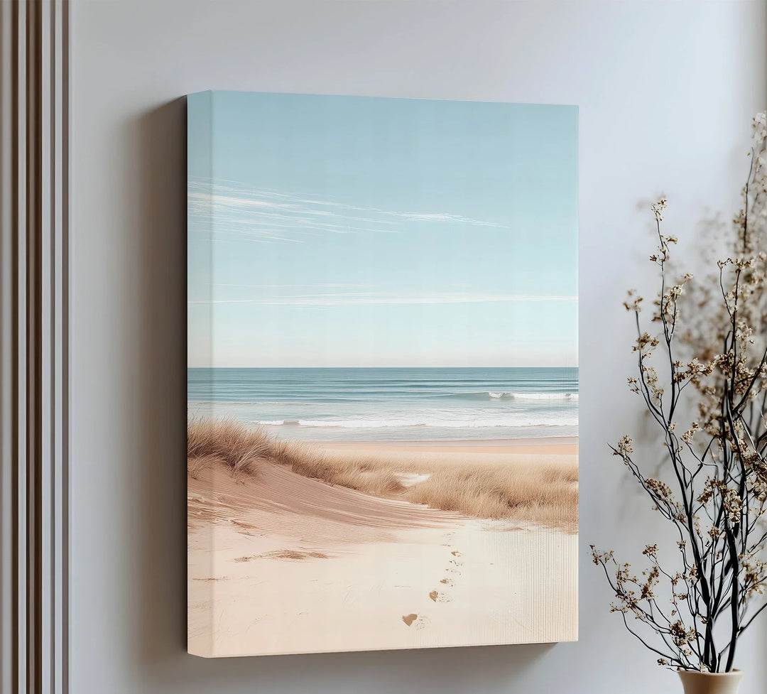 Bring calm to your space with this minimalist canvas print of sandy shores and gentle waves.