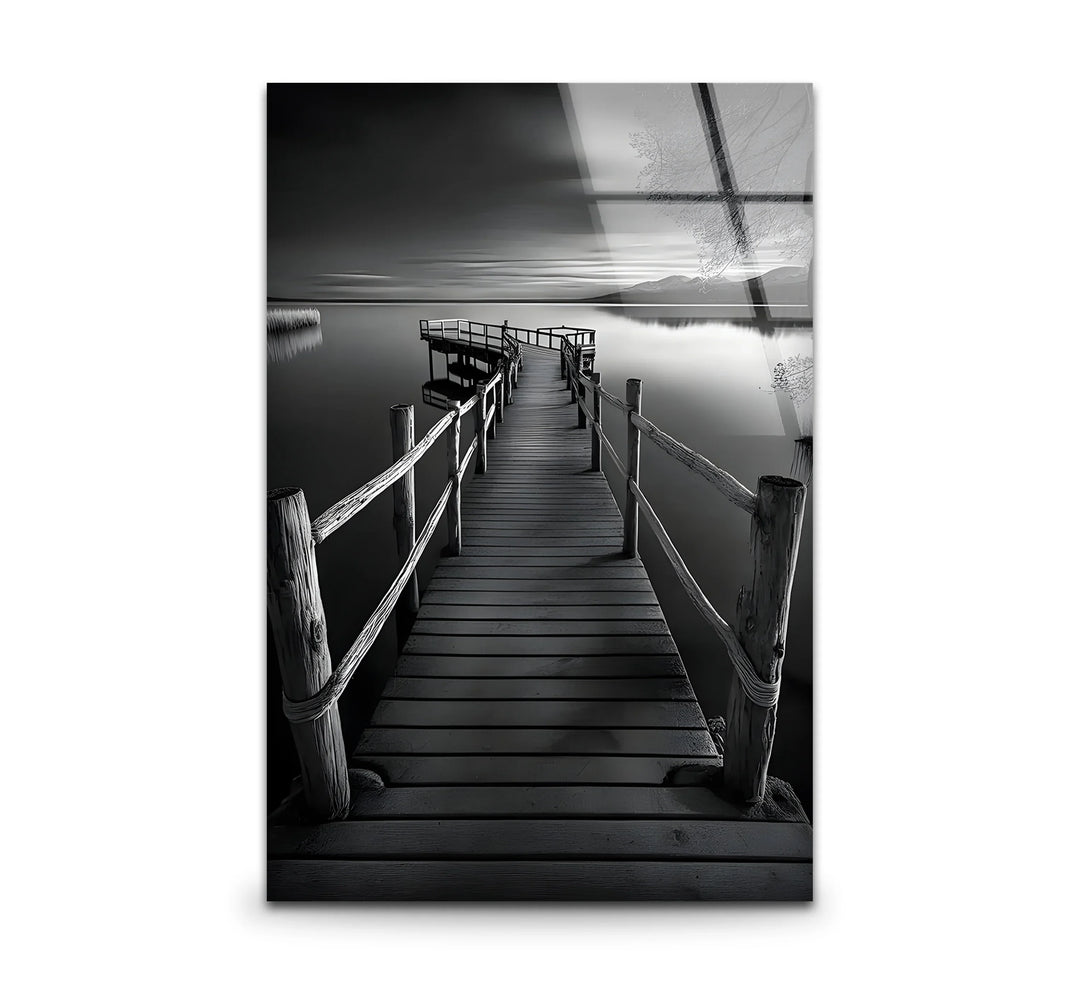 Peaceful black and white art featuring a dock extending into a calm lake
