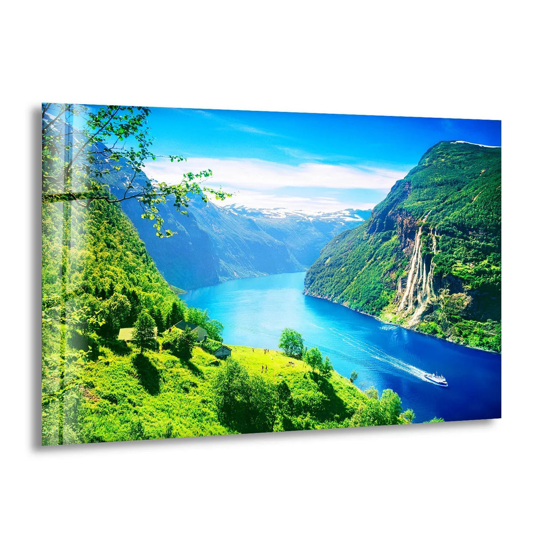 Geirangerfjord Norway Glass Wall Art featuring a breathtaking view of lush green mountains and deep blue waters.