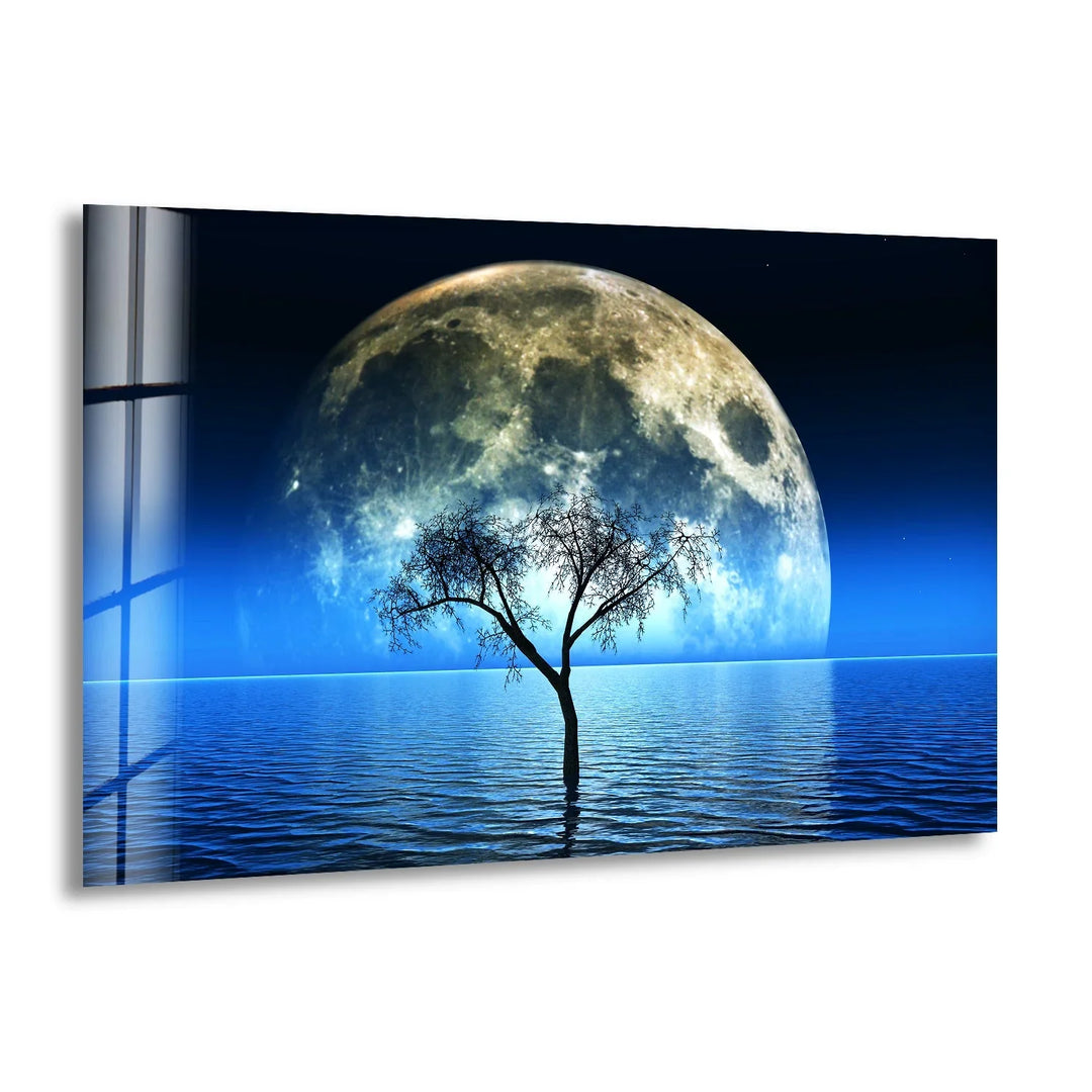 A stunning glass wall art featuring a luminous full moon rising over a tranquil water landscape.