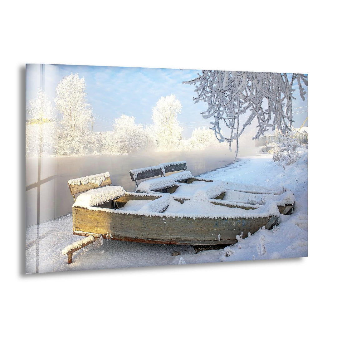Serene winter landscape featuring a snow-covered wooden bench and frosty trees, printed on glass wall art.