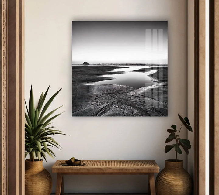 A mesmerizing black and white coastal view captured on glass, bringing a sense of tranquility to your living space.