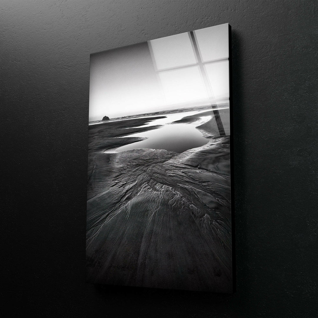 A striking seaside view on tempered glass, with dramatic black and white tones highlighting the beauty of the beach.