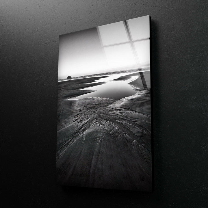 A striking seaside view on tempered glass, with dramatic black and white tones highlighting the beauty of the beach.