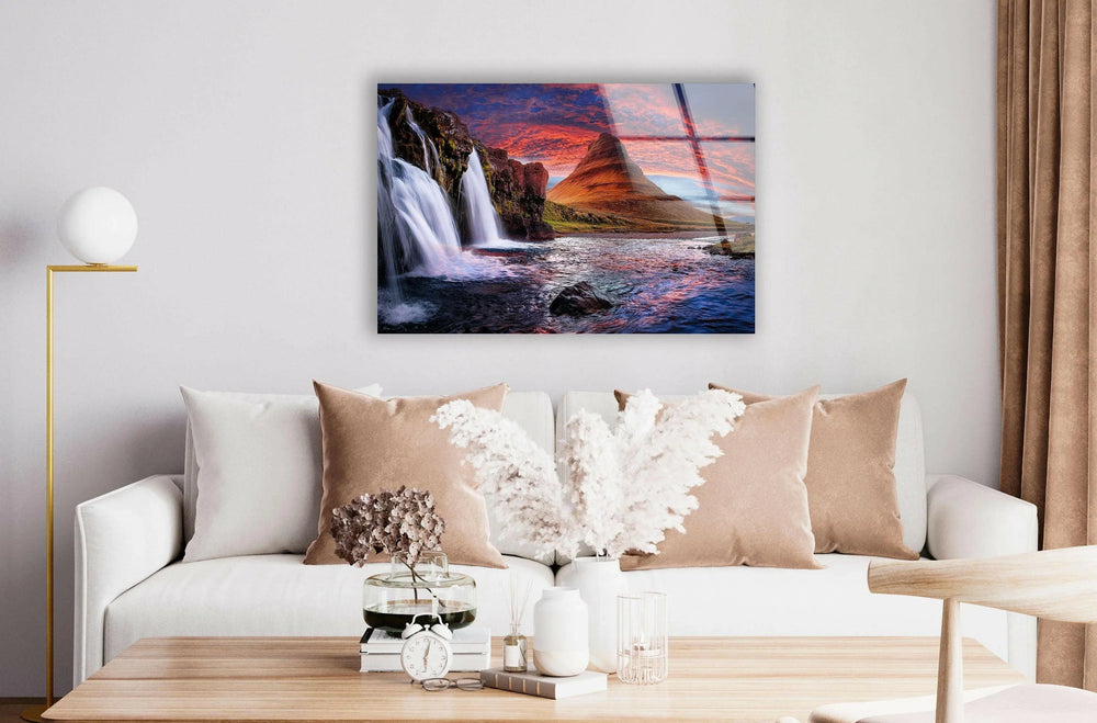 Majestic waterfall with vibrant sunset hues, creating a stunning landscape view.