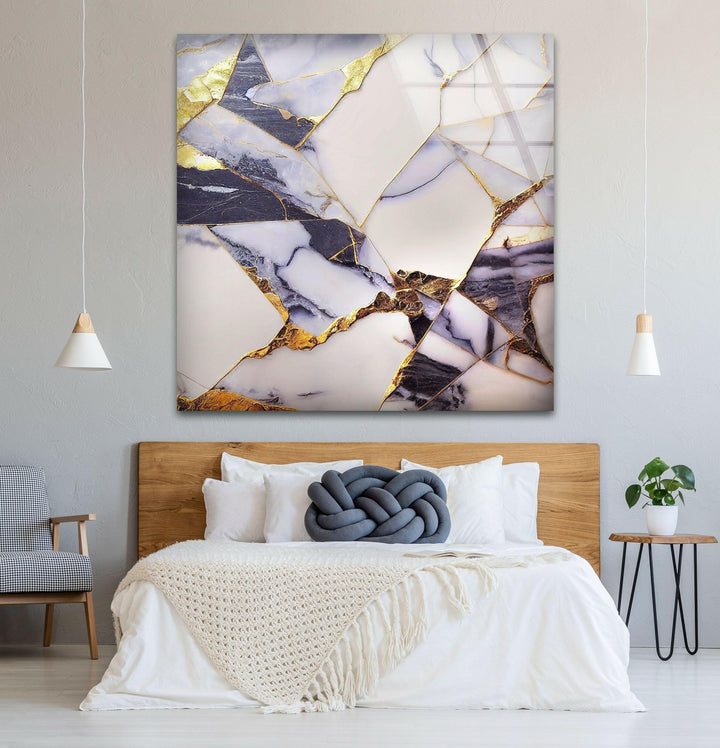 a bed with a white blanket and a painting on the wall