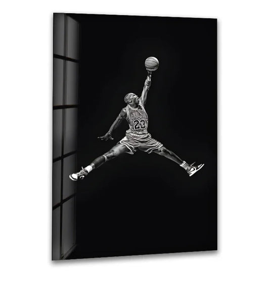 Sports glass wall art shows Michael Jordan dunking in black and white and a legendary basketball image for modern sports fans