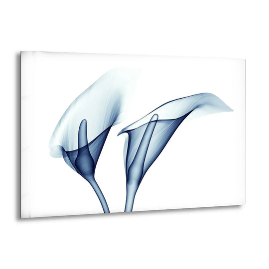 Two ethereal blue calla lilies evoke a serene stillness in this striking glass wall art home decoration.