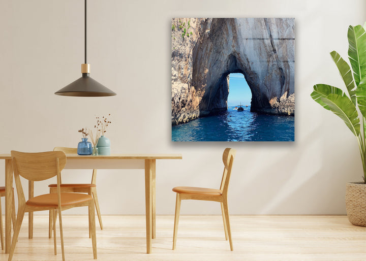 Modern home decor featuring a majestic rock archway over calm, blue ocean waves.
