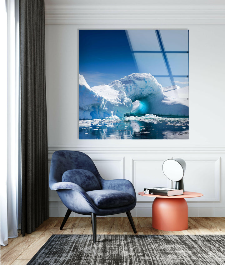 Nature-inspired artwork featuring a striking iceberg with a glowing blue ice cave.
