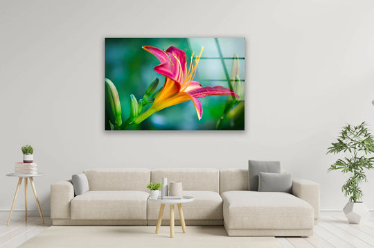 A vibrant pink lily closeup glows with warm orange hues, beautifully rendered as a glass wall art print.