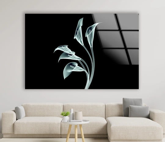 Frameless edges and a glossy border define this piece of unique modern wall decor, an elegant calla lily glass art print against a stark black backdrop.