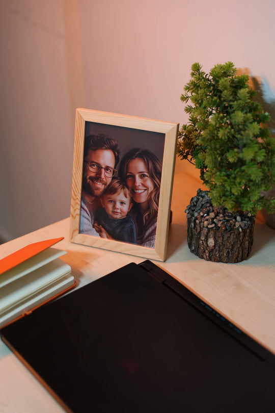 Showcasing the realistic detail of a framed custom natural wood photo print, capturing a family portrait with such clarity, it looks like custom glass pictures.