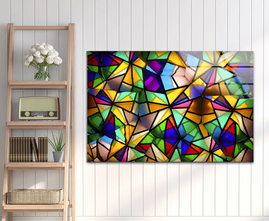 An abstract glass art painting features kaleidoscopic organic forms composed of vibrant, jewel-toned geometric shards creating a luminous glow.
