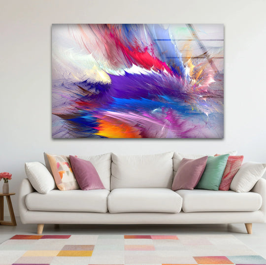 Abstract wall art prints featuring a vibrant explosion of colors above a contemporary white sofa.