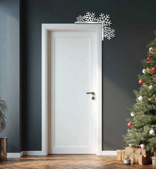Low color saturation highlights the minimalist frosted snowflakes metal wall decor as a subtle, chic winter accent with festive metal wall decor.