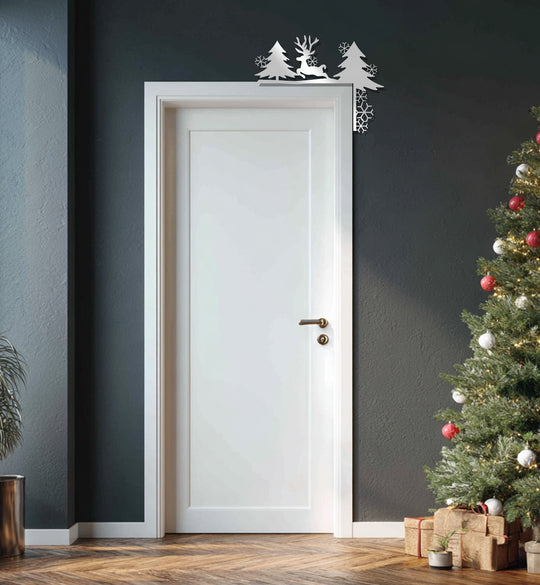 The Christmas metal fireplace décor featuring a reindeer and pine trees silhouette exemplifies unique metal wall art, adding a festive touch to the door frame.