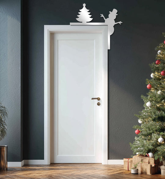 The darkest area showcases a silver unique metal wall art of a snowman and Christmas tree adorning a doorframe, perfect for holiday fireplace décor.