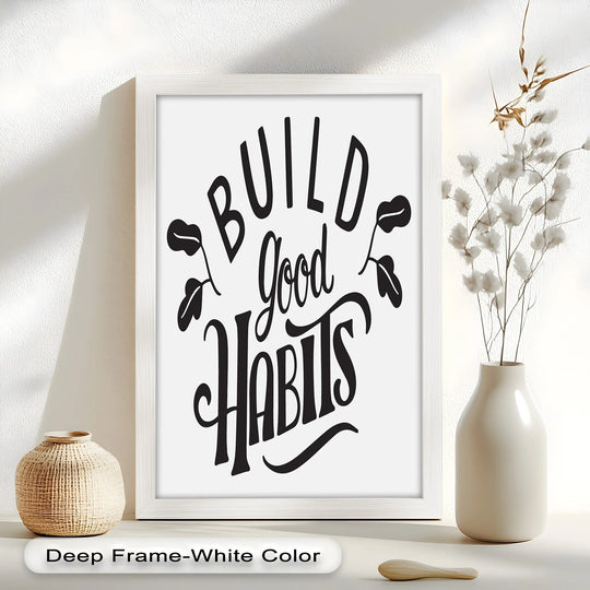 Gentle light caresses the motivational 'Build Good Habits' oil painting decoration, highlighting its textured frame beside the smooth vase of cotton blooms.