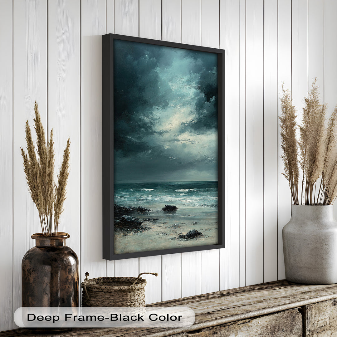 This moody seascape painting captures a dramatic moment on a rocky shoreline beneath a turbulent sky, as waves roll gently toward the sand.