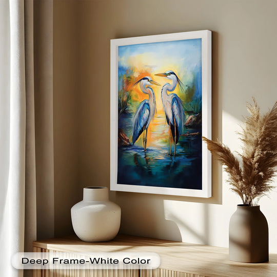 Foreground shows a white vase and pampas grass next to a heron duo oil painting wall art in a deep white frame, enhancing the home decor.