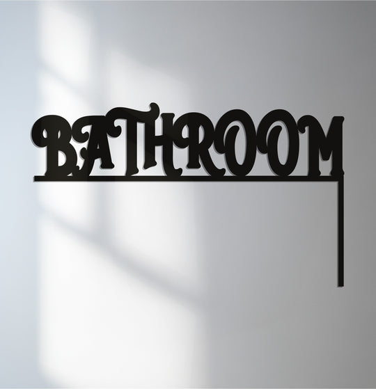Black finish on the metal art for wall provides a sleek contrast to the elegant 'Bathroom' door sign décor, adding a touch of modern sophistication.