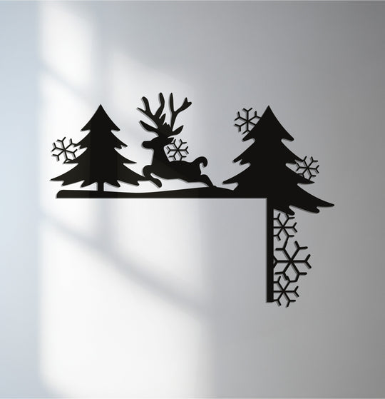 Against the minimalist background, the unique metal wall art Christmas fireplace decor depicts a reindeer amongst pine trees with delicate snowflake accents.