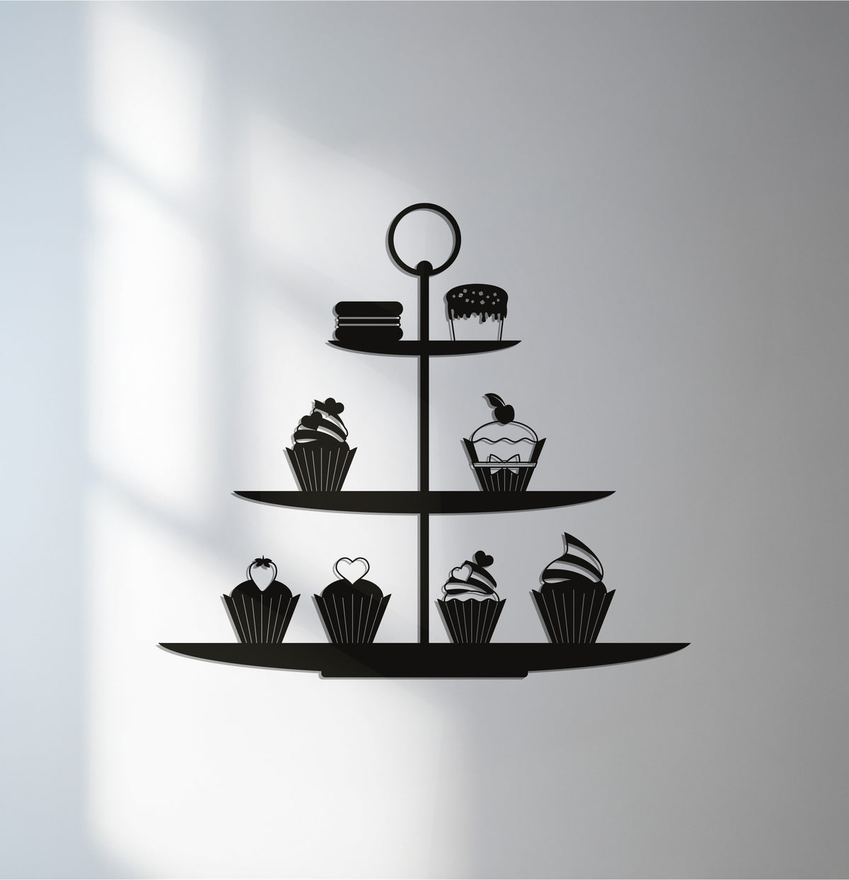 Showcasing the realistic detail, this black metal cupcake stand silhouette presents charming decoration wall art, perfect for adding a touch of sweetness to a kitchen or bakery space.