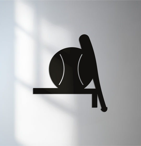 Low color saturation emphasizes the sleek black silhouette of the decoration wall art depicting a baseball bat and ball.