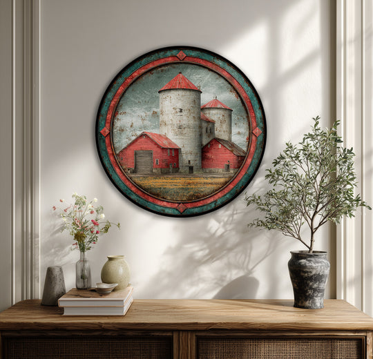 Distressed surface texture defines this round canvas wall decor featuring a rustic red barn and silos landscape, adding a vintage farmhouse feel to the canvas print.