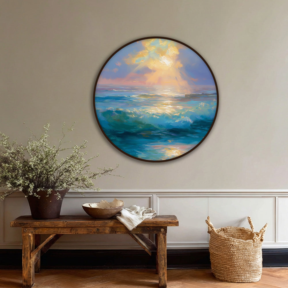 Horizontal round canvas art print shows a serene golden light over turquoise waves of a sunrise ocean scene.