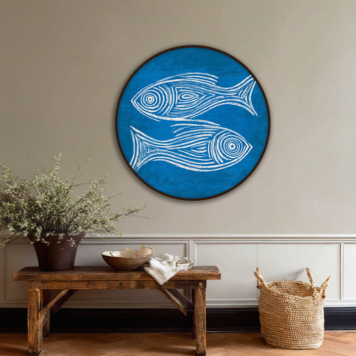 Illuminated by the brightest area, this round canvas artwork presents a minimal blue fish sketch, embodying coastal wall art in a captivating design.