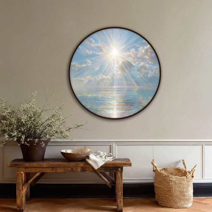 Light and shadow play across the luminous ocean in this round canvas artwork of celestial sun rays, creating a serene and radiant scene.
