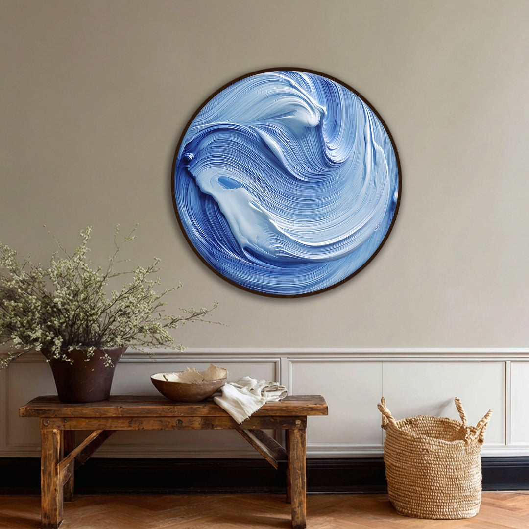 Visually striking abstract canvas painting depicts an ocean flow of swirling blue and white waves, capturing the modern and fluid nature of the round wave wall art.