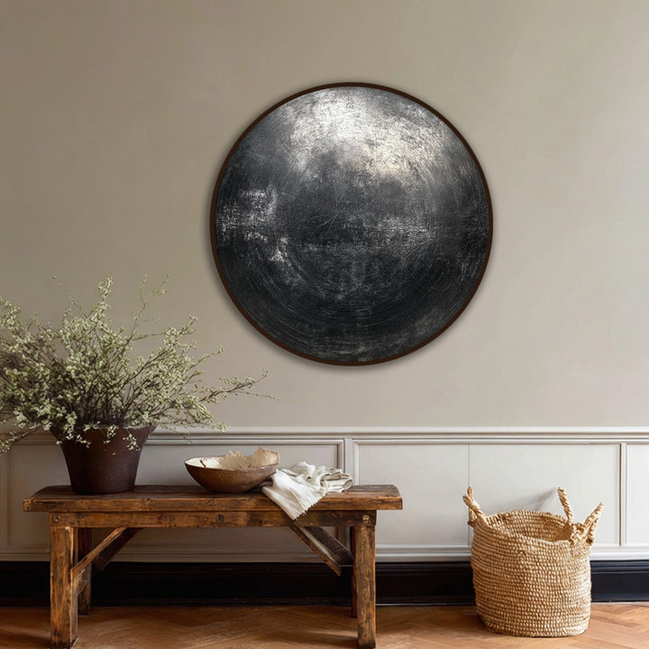 Delicate floral branches complement the industrial black textured abstract circle premium canvas decor, creating a soft visual contrast in this modern wall art display.