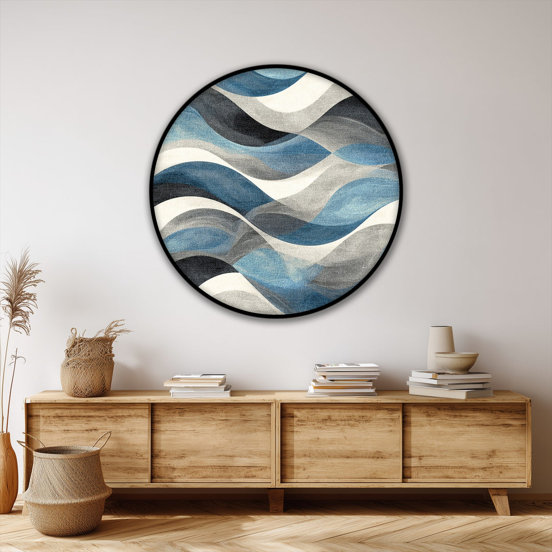 High color saturation enhances the flowing blue waves on this round canvas artwork, a modern coastal wall art print with an abstract design.