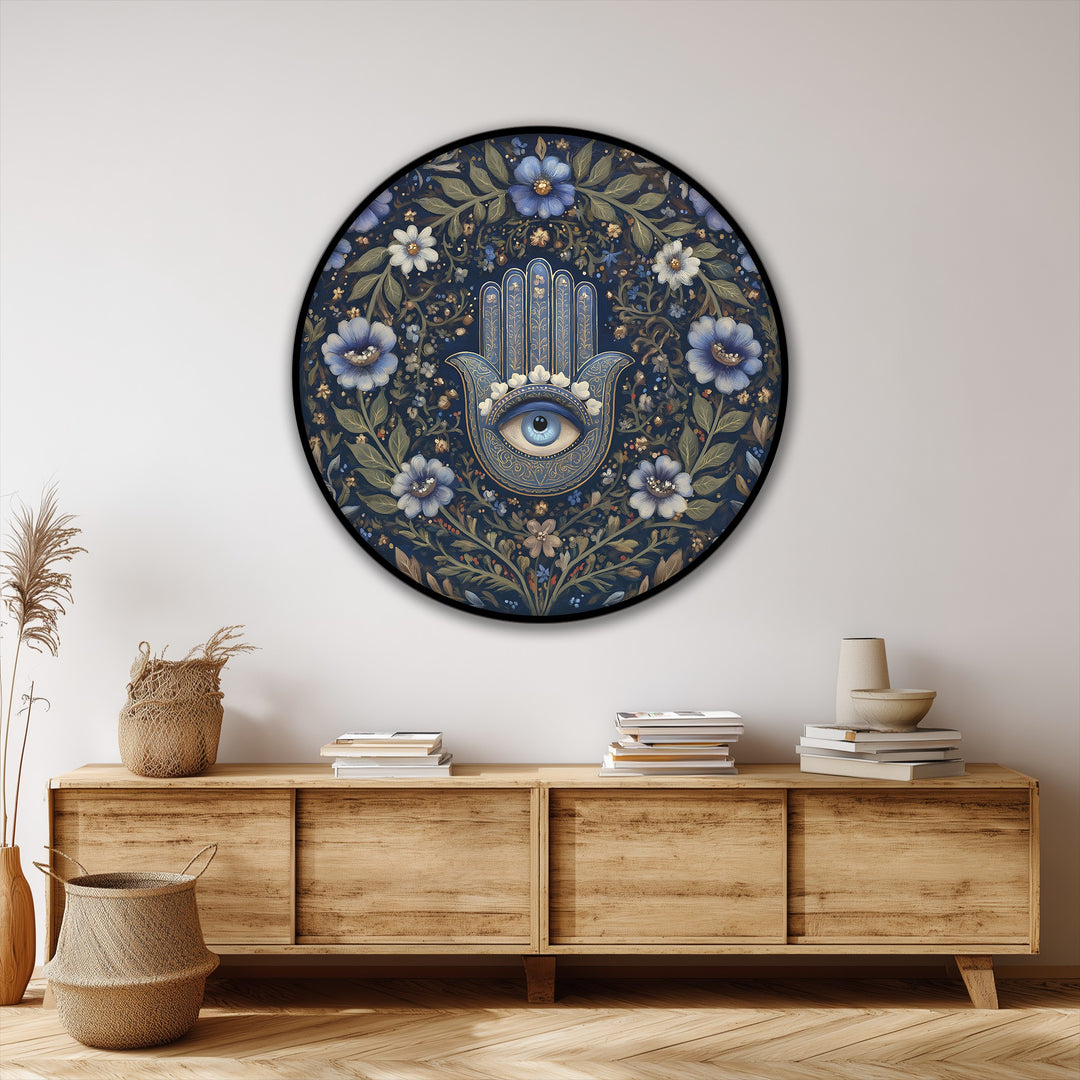 Circular canvas wall art featuring a central Hamsa hand and eye design, surrounded by a geometric arrangement of blue and white floral elements.