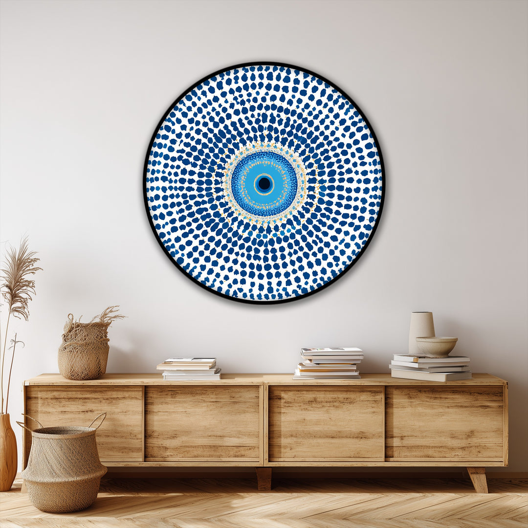 Subtle light play emphasizes the textures and shadowed recesses of this protective symbol, a round canvas painting with a mesmerizing blue evil eye mandala design.