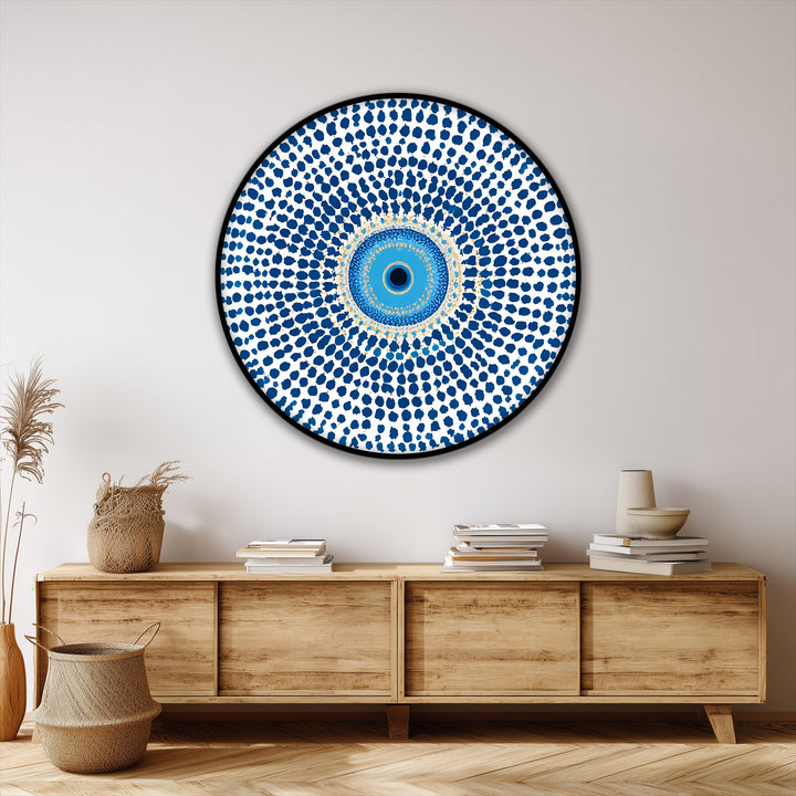 Subtle light play emphasizes the textures and shadowed recesses of this protective symbol, a round canvas painting with a mesmerizing blue evil eye mandala design.