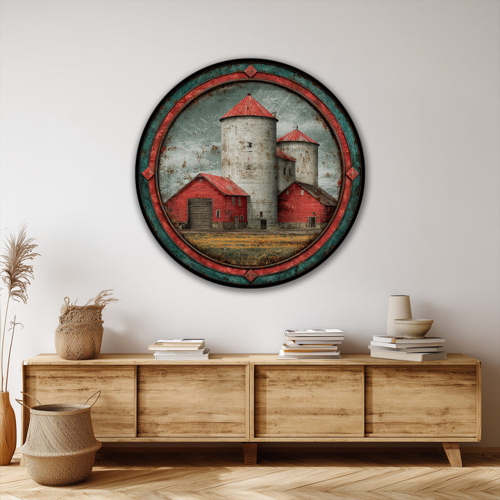 Horizontal, round canvas artwork showcases a rustic red barn and silos landscape, featuring vintage farm wall art in a circular orientation.