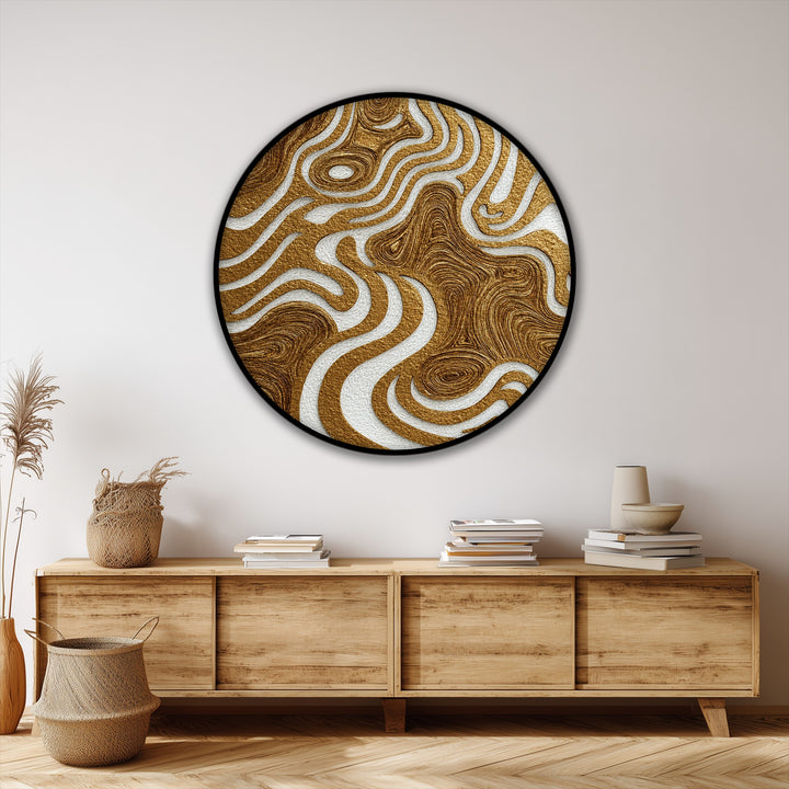 Neutral wall and wooden furnishings accentuate the round canvas hanging canvas, showcasing its textured, golden organic flow abstract design.