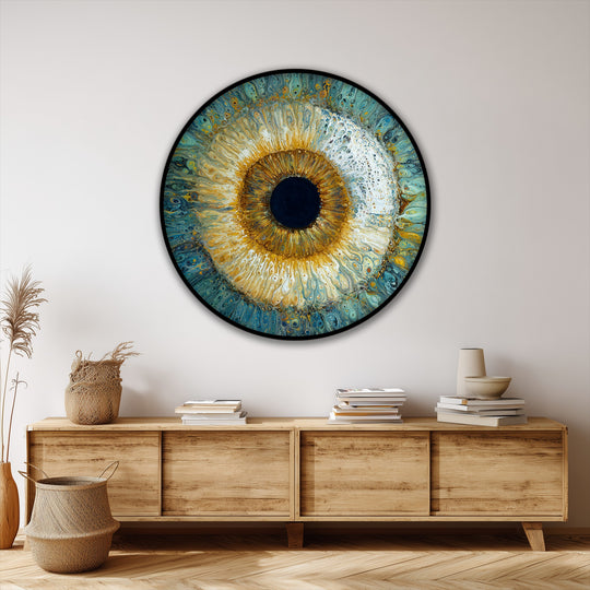 Softest blending highlights the round canvas painting of a radiant abstract eye, creating a mesmerizing fluid art wall decor piece in captivating gold and blue hues.