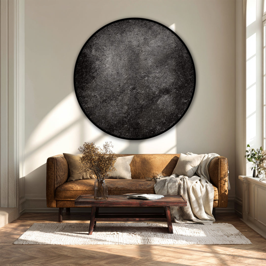 Sunlight creates distinct light and shadow patterns that play across this modern black round canvas art print, enhancing the dark texture and minimal design of this canvas art.