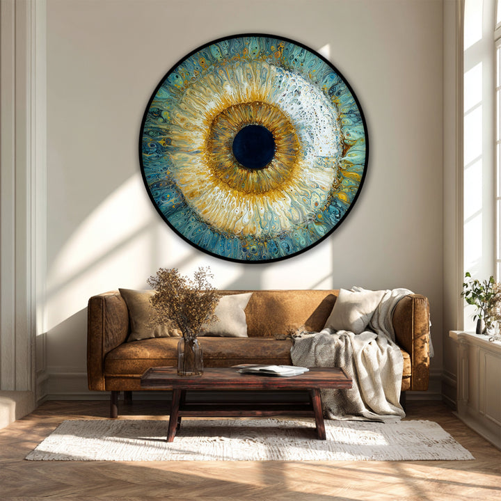 Up close, the abstract radiant eye design shows off premium canvas decor through swirling golds and blues, adding a focal point to this round fluid art wall decor.