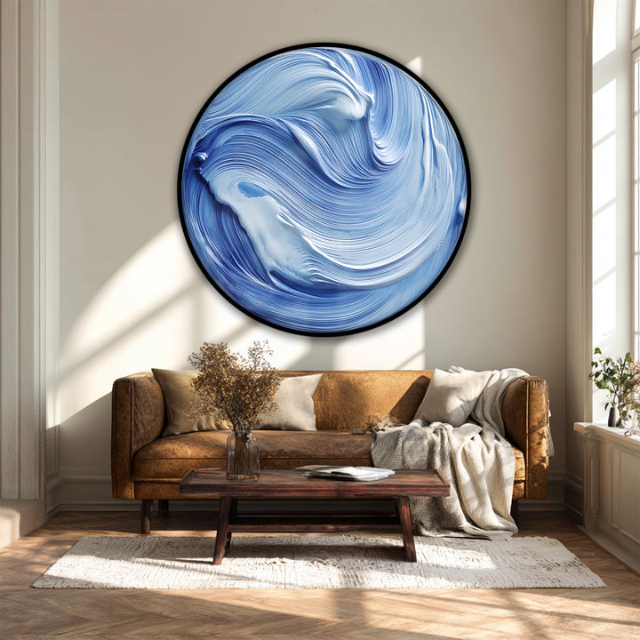 The canvas wall art displays a striking, high color saturation, emphasizing the swirling ocean flow in this blue abstract round canvas print.