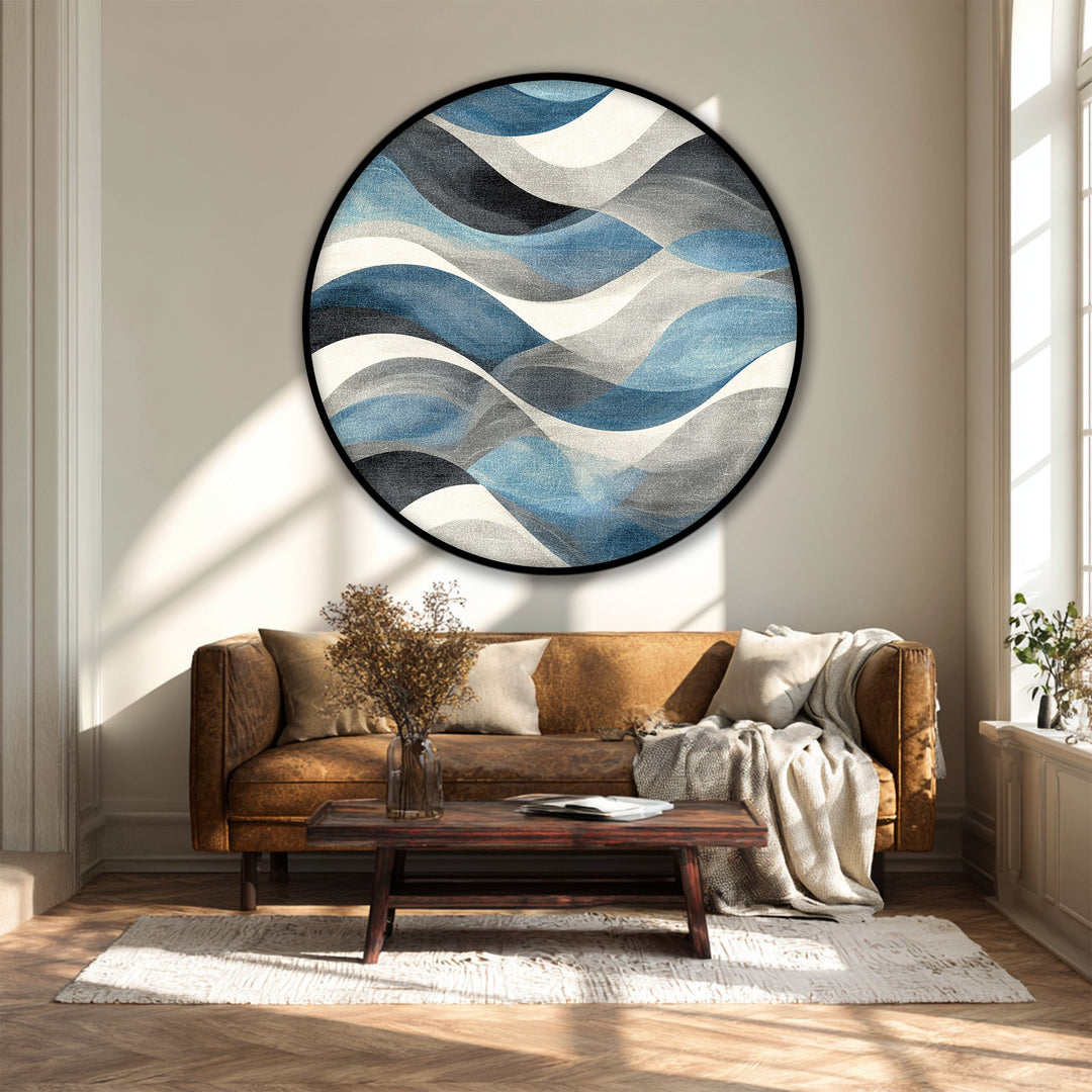 Sunlight casts distinct light and shadow patterns that highlight the texture of this flowing blue waves abstract round premium canvas decor art.