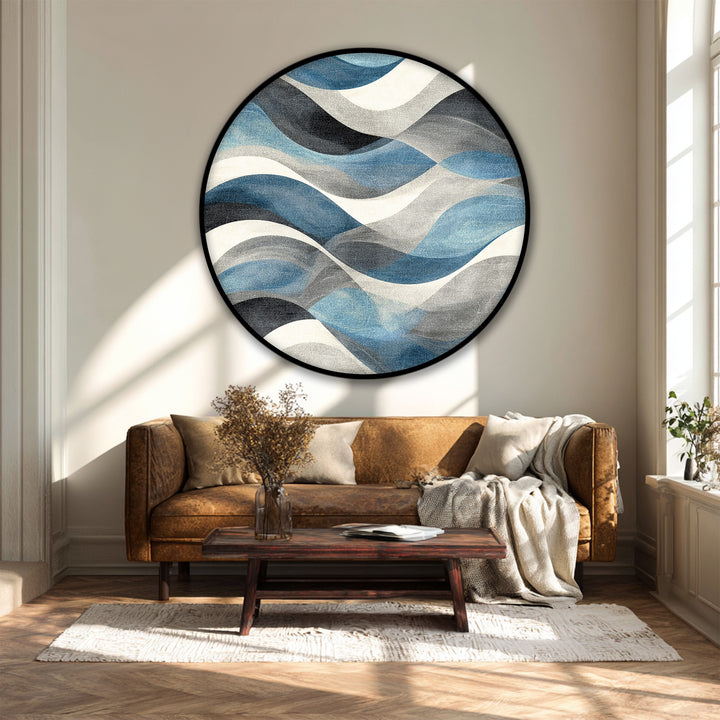 Sunlight casts distinct light and shadow patterns that highlight the texture of this flowing blue waves abstract round premium canvas decor art.
