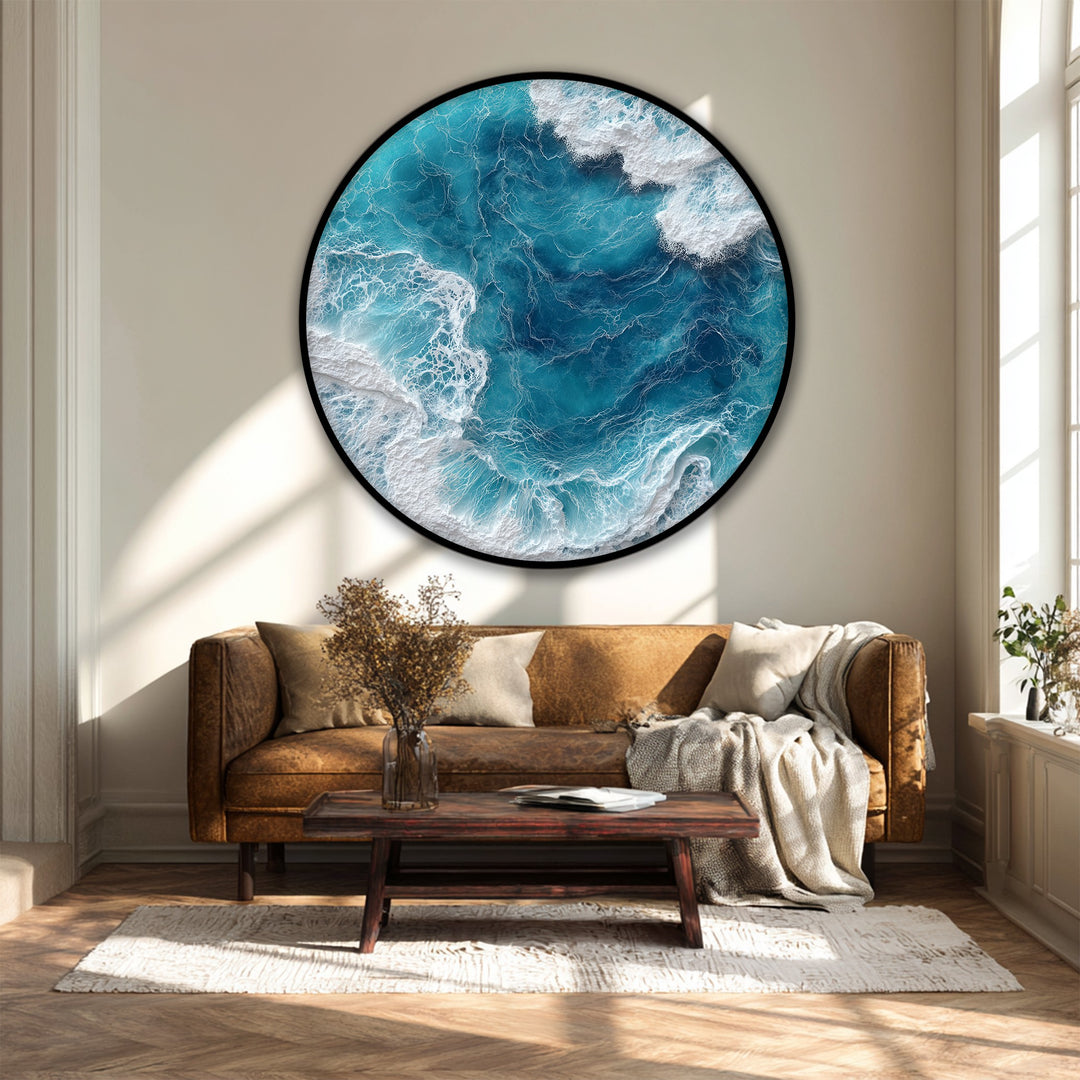Sunlight illuminates the bright white surf of the turquoise ocean in this round framed canvas art print, an aerial view of captivating sea waves.